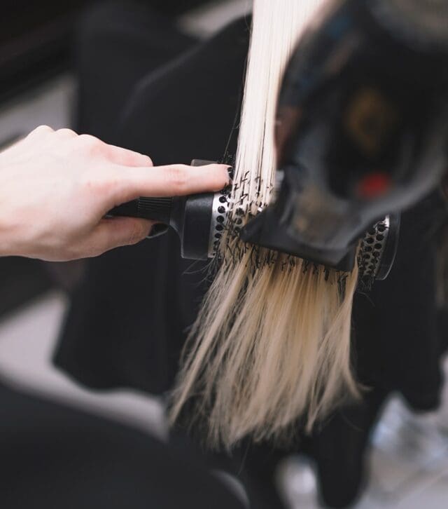 crop-stylist-setting-hair-with-brush