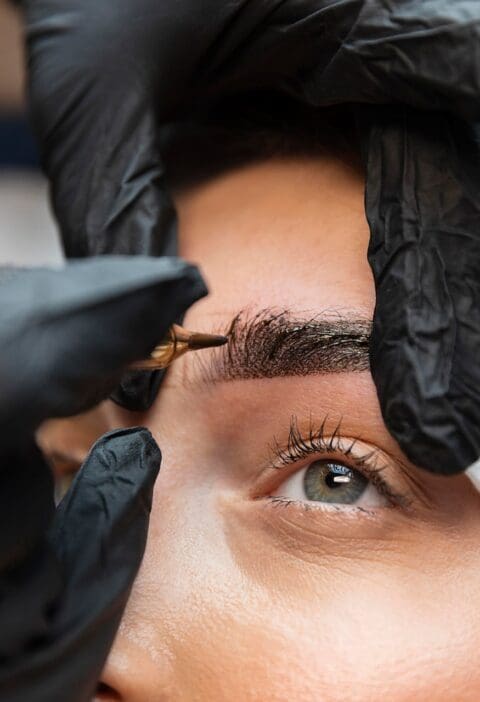 young-woman-getting-beauty-treatment-her-eyebrows